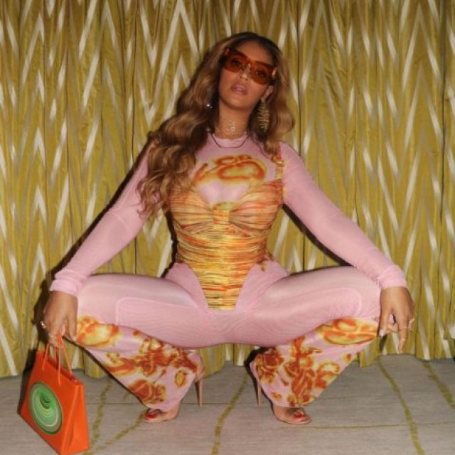 Beyonce posed in a pink outfit