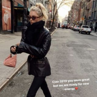 Elsa Hosk walks in Brooklyn in a black leather jacket