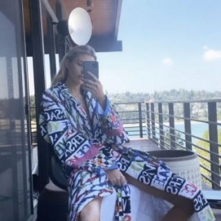Stella Maxwell is relaxing in a sexy Versace dressing gown