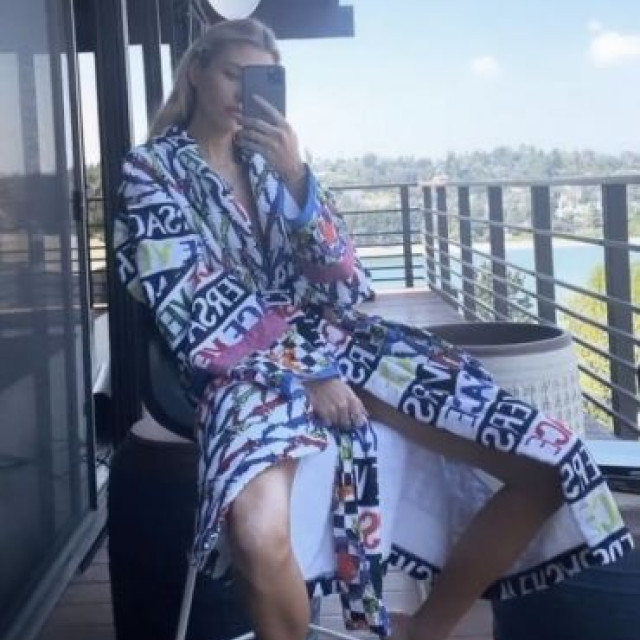 Stella Maxwell is relaxing in a sexy Versace dressing gown