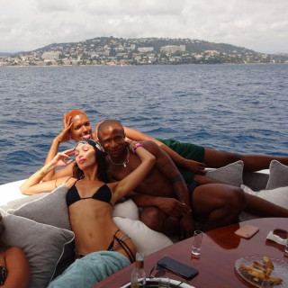Bella Hadid in a bright outfit on vacation with friends on a yacht