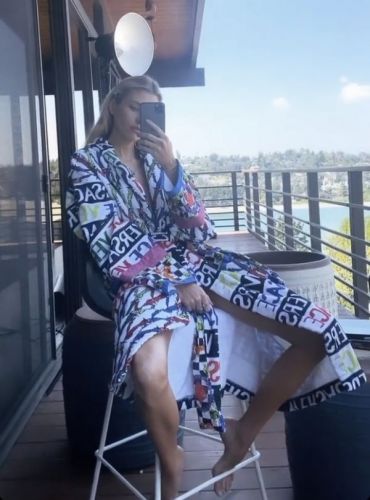 Stella Maxwell is relaxing in a sexy Versace dressing gown